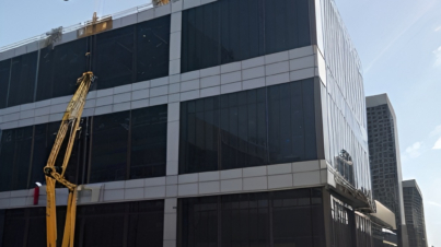 openart-scene-a-nearly-finished-glass-and-steel-office-building-with-workers-insta